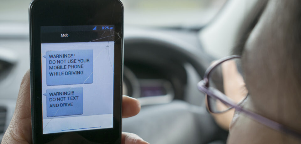 Photo warning and hopefully encouraging people not to use mobile phones while driving