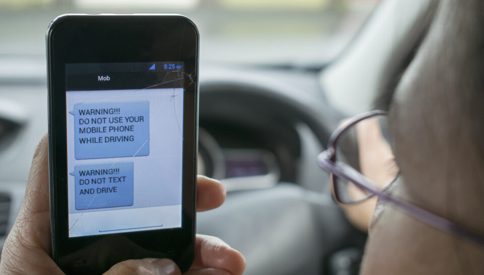 Photo warning and hopefully encouraging people not to use mobile phones while driving