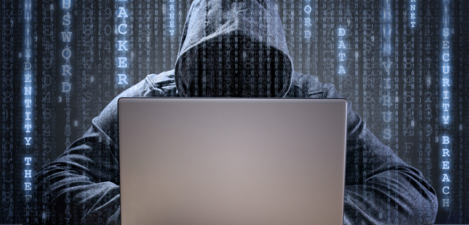 Computer hacker stealing data from a laptop concept for network security, identity theft and computer crime