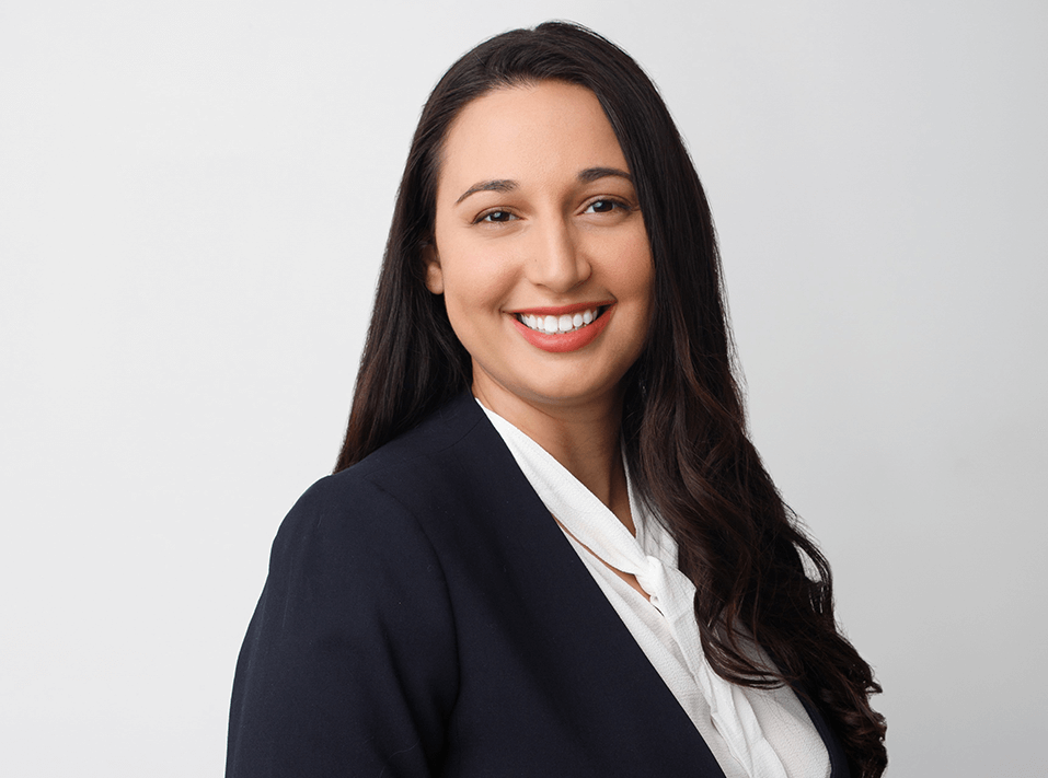 A professional headshot of attorney Adriana Rodriguez smiling.