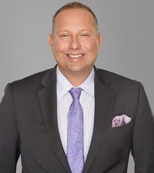 A professional headshot of attorney Joseph Schulz smiling slightly.