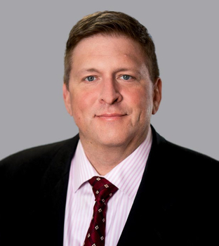 A professional headshot of attorney Matthew Moore smiling.